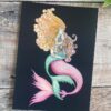 Pink mermaid with green tailed merchild on a black background